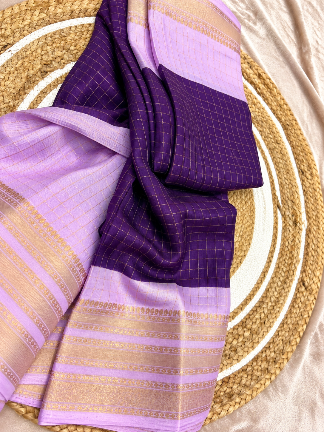 Purple saree folded with jasmine flowers and gold bangles