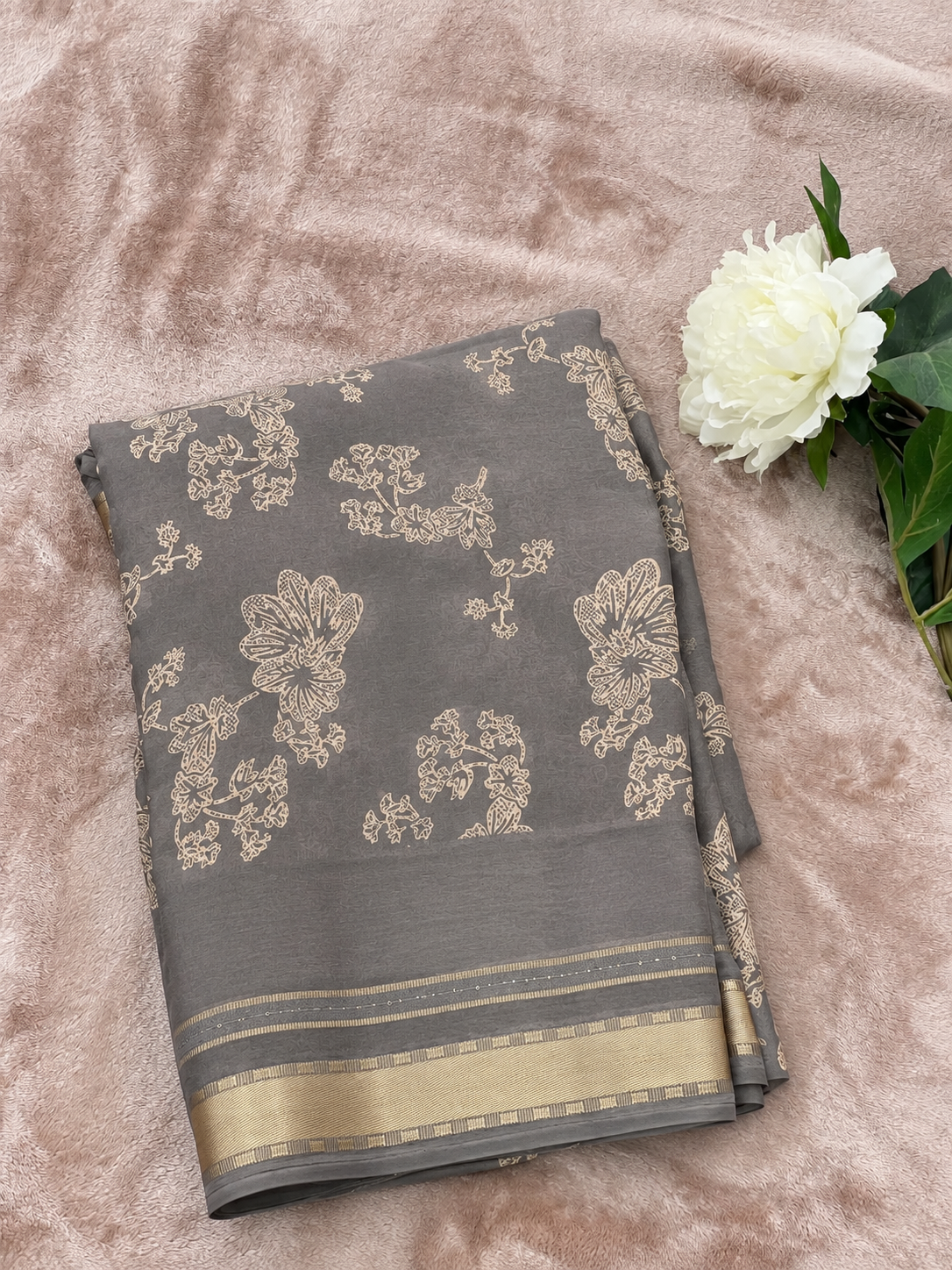 Steel grey saree brightened flat lay with white peony