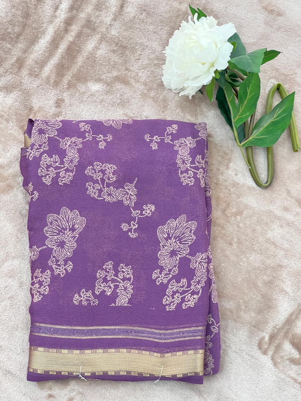 Dusty purple saree folded showing large cutdana floral work and gold zari border