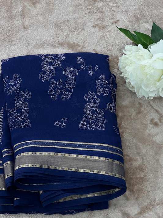 Royal blue saree folded flat lay with white peony