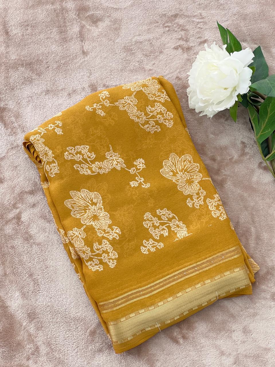 Golden mustard saree folded flat lay showing large floral cutdana work