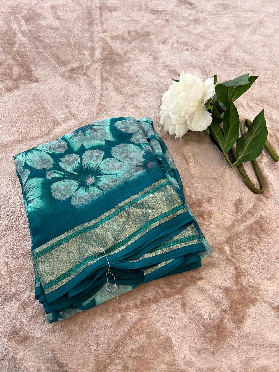 Rasmalai teal saree neatly folded showing gold-green tissue border stripe detail