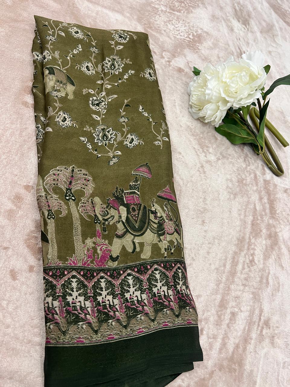 Olive green saree folded flat lay with white peonies