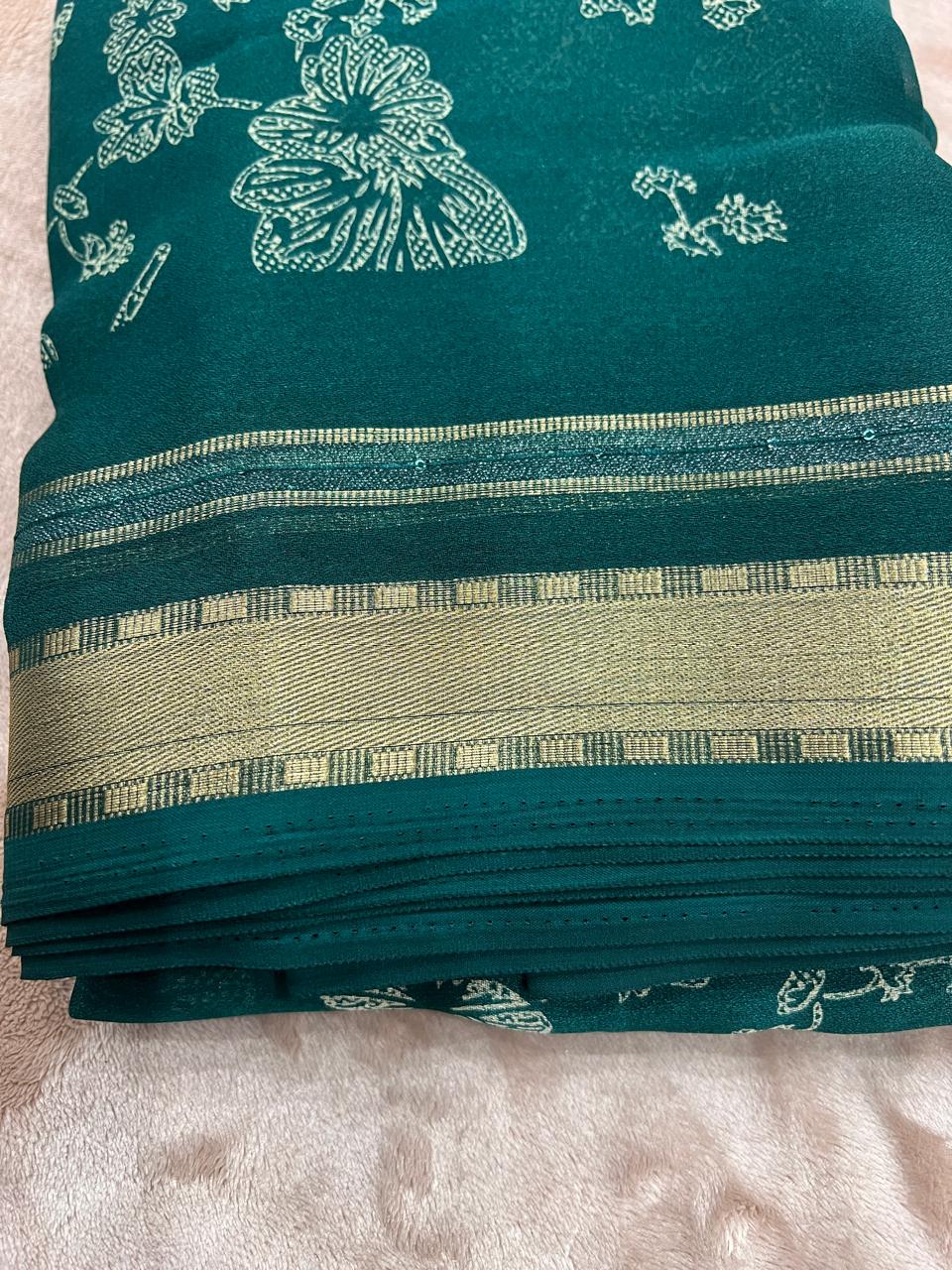 Emerald green saree draped flat with white peony