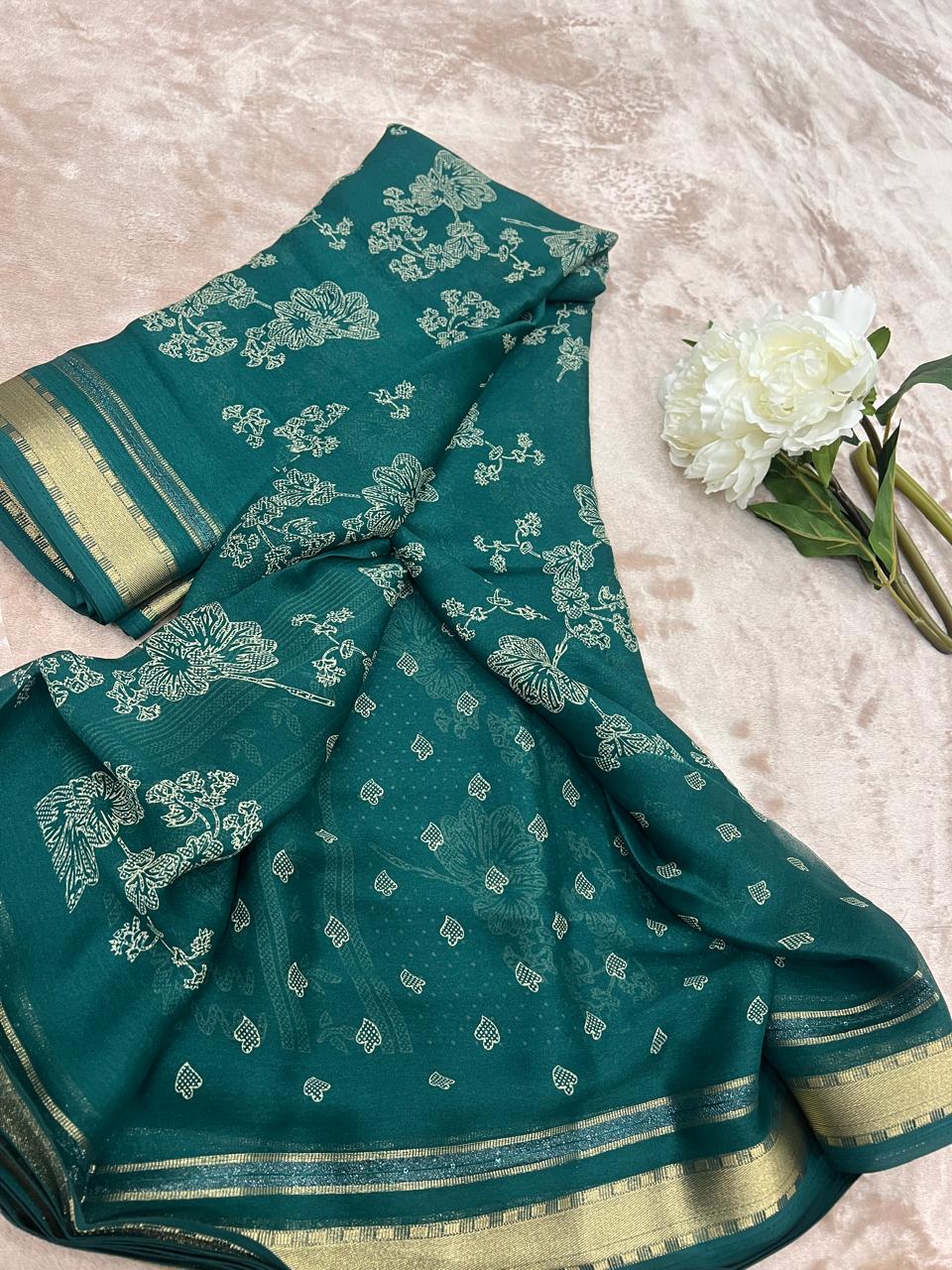 Ivory floral print close-up on emerald green fabric