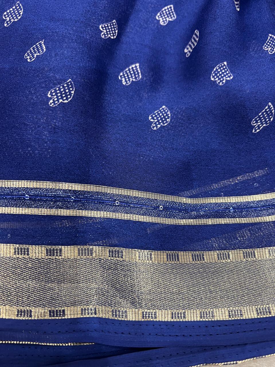 Royal blue saree draped showing heart butti and zari border