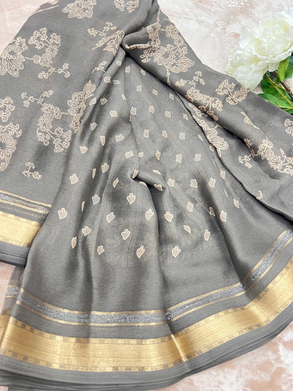 Steel grey saree draped showing heart butti and gold zari border