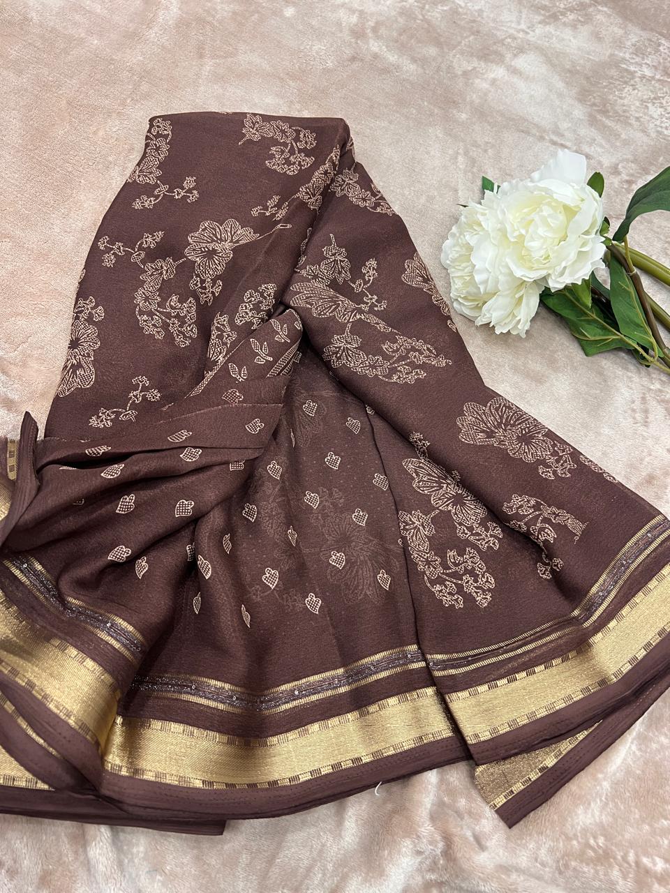 Chocolate brown saree draped showing floral cutdana work and gold zari border