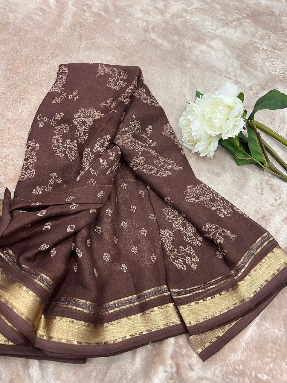 Chocolate brown saree flat lay close-up showing heart butti and cutdana details