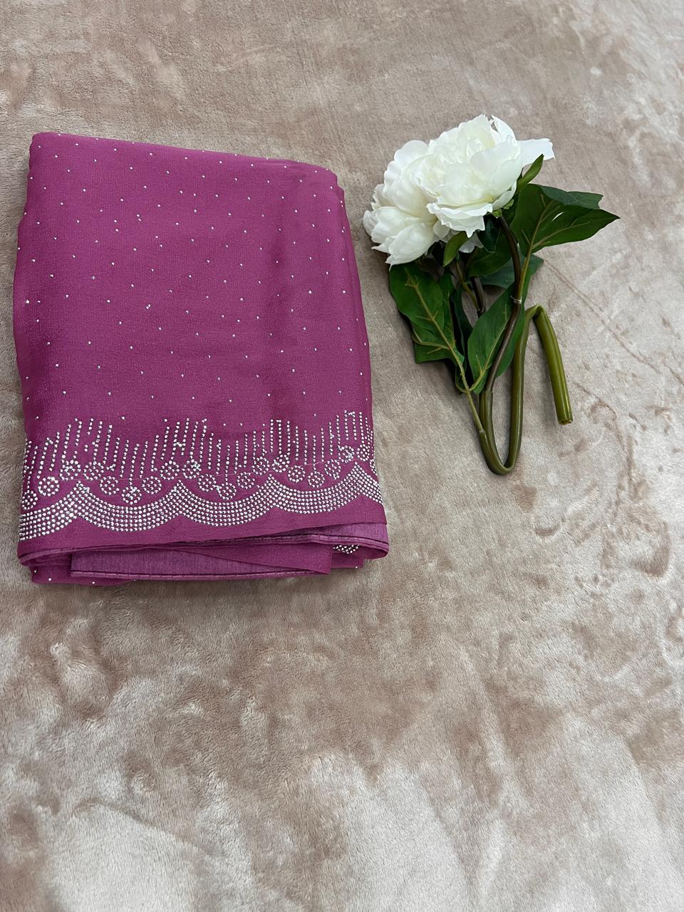 Magenta saree flat lay with white peony showing cutdana dot scatter and scallop border