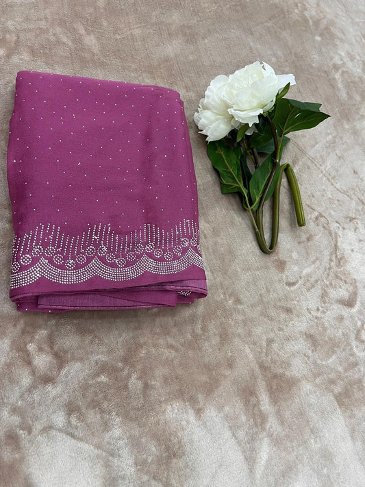 Magenta saree flat lay with white peony showing cutdana dot scatter and scallop border