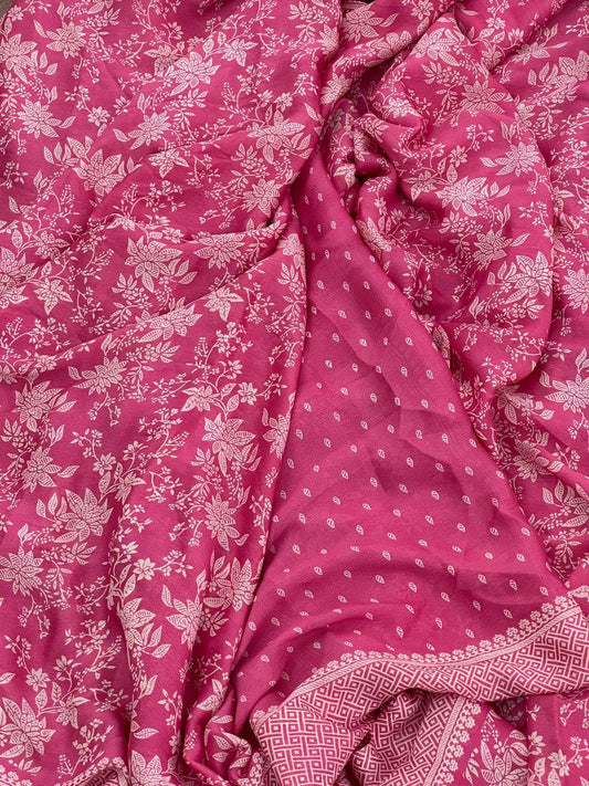 Rose pink saree draped flat showing all-over botanical floral print and geometric lattice border
