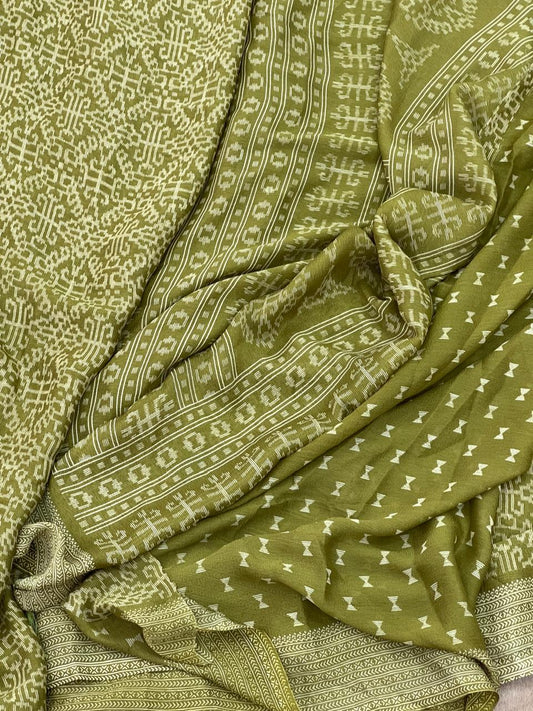 Olive green ikat tribal geometric print saree flat lay showing all-over cream medallion print and chevron border